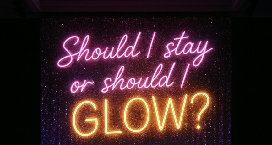 Neon sign reading “Should I stay or should I glow?” symbolizing self-reflection and empowerment during divorce or relationship transitions.